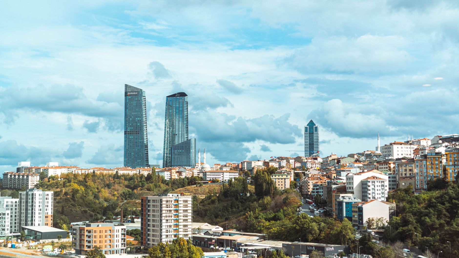 Panoramic cityscape with modern skyscrapers and scenic urban surroundings.