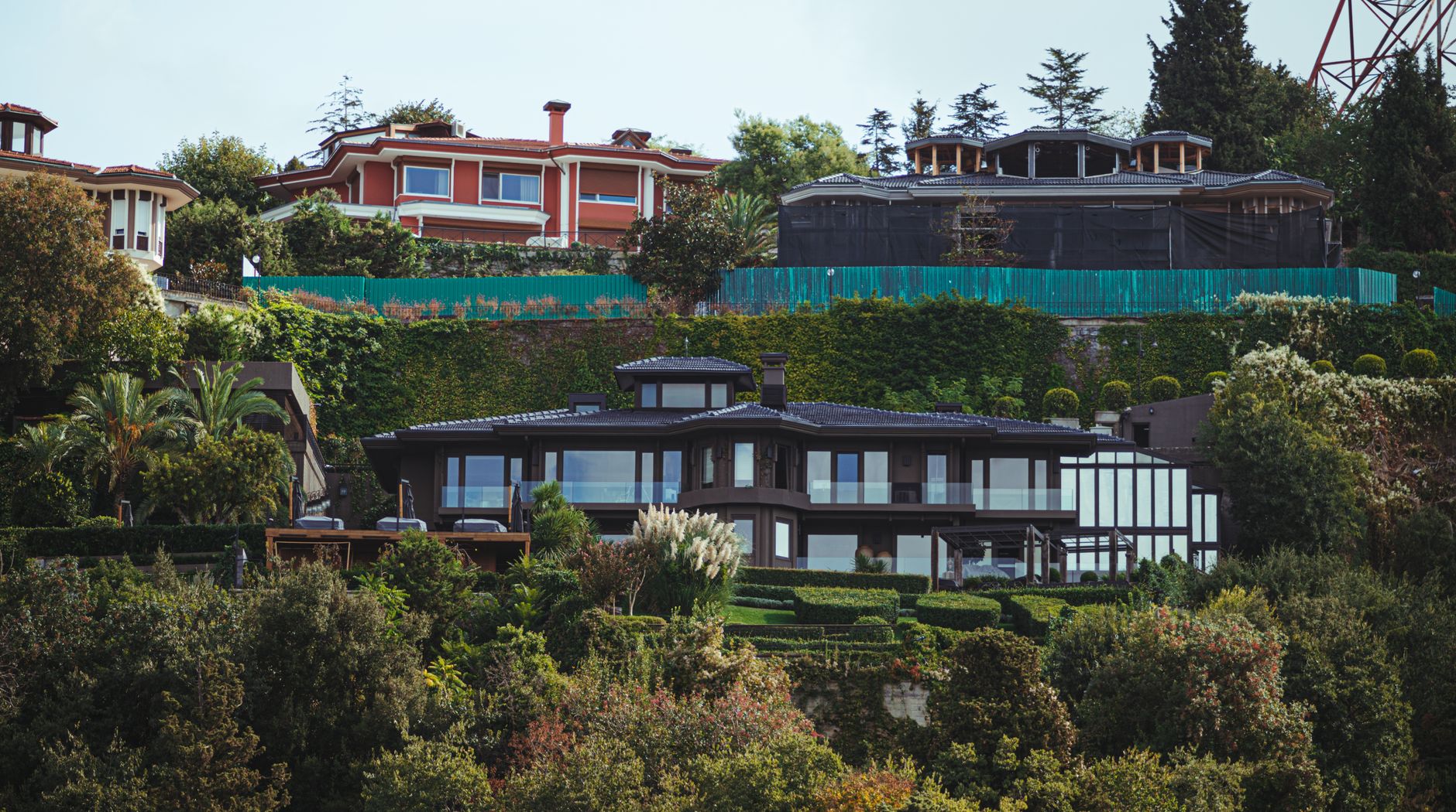 Stunning view of luxurious mansions surrounded by lush vegetation with a modern architectural design.